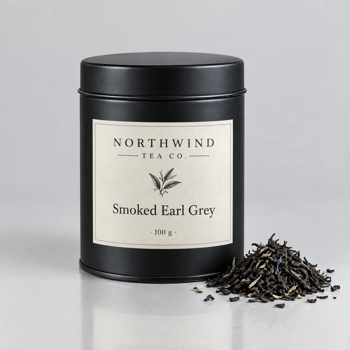 GPT Image 2.5 studio product shot of a matte black tea tin with a cream label reading Northwind Tea Co. Smoked Earl Grey 100 g